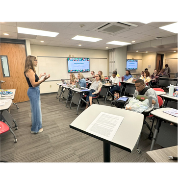 Photo of one of the workshop sessions. Presenter at the front of the room talking to the participants. 